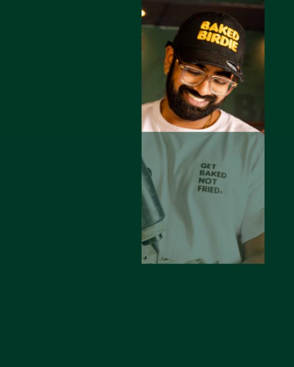 Shai, one of Baked Bird's founders saucing some wings at an event.